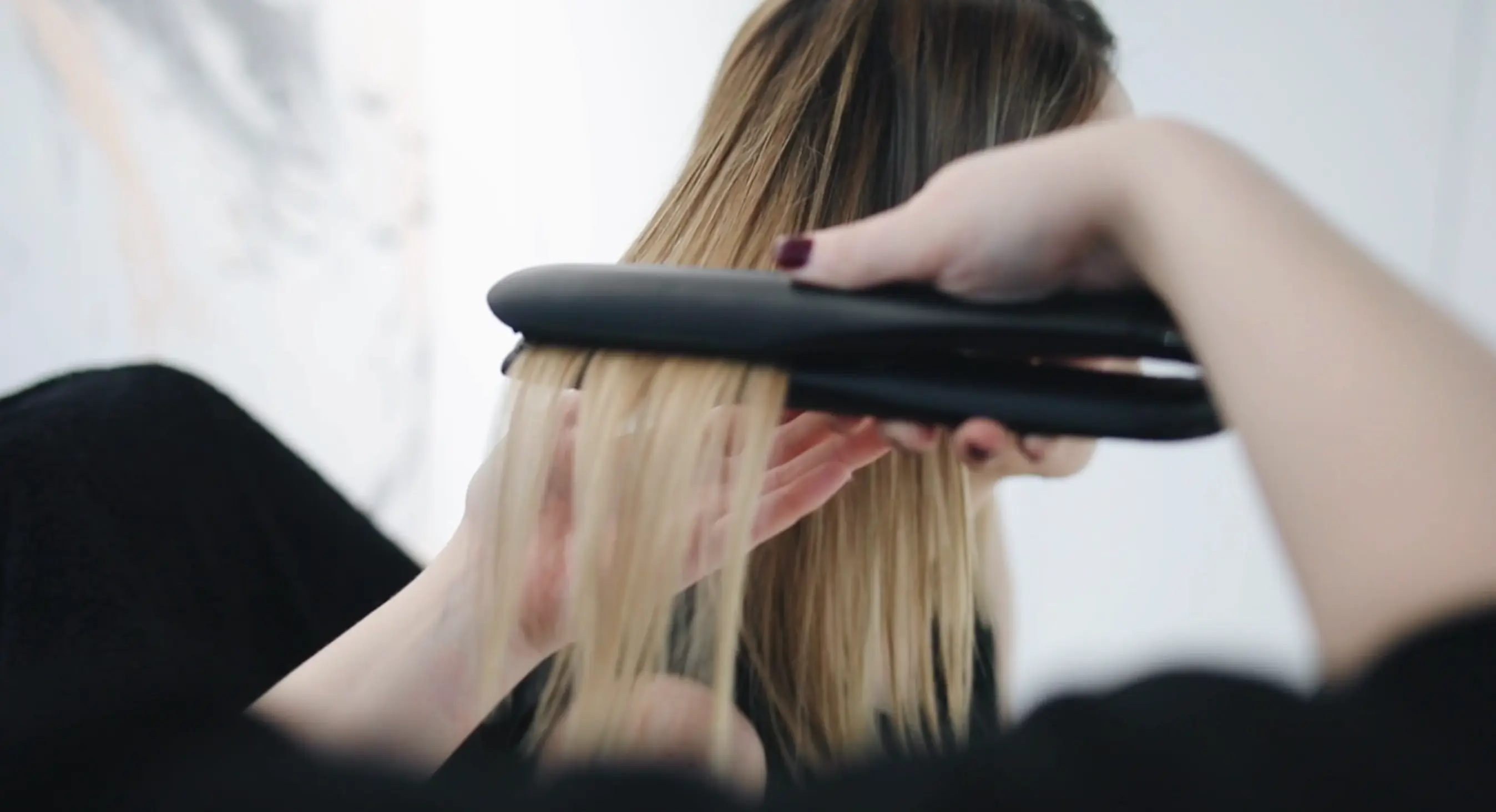 A girl straightening hair